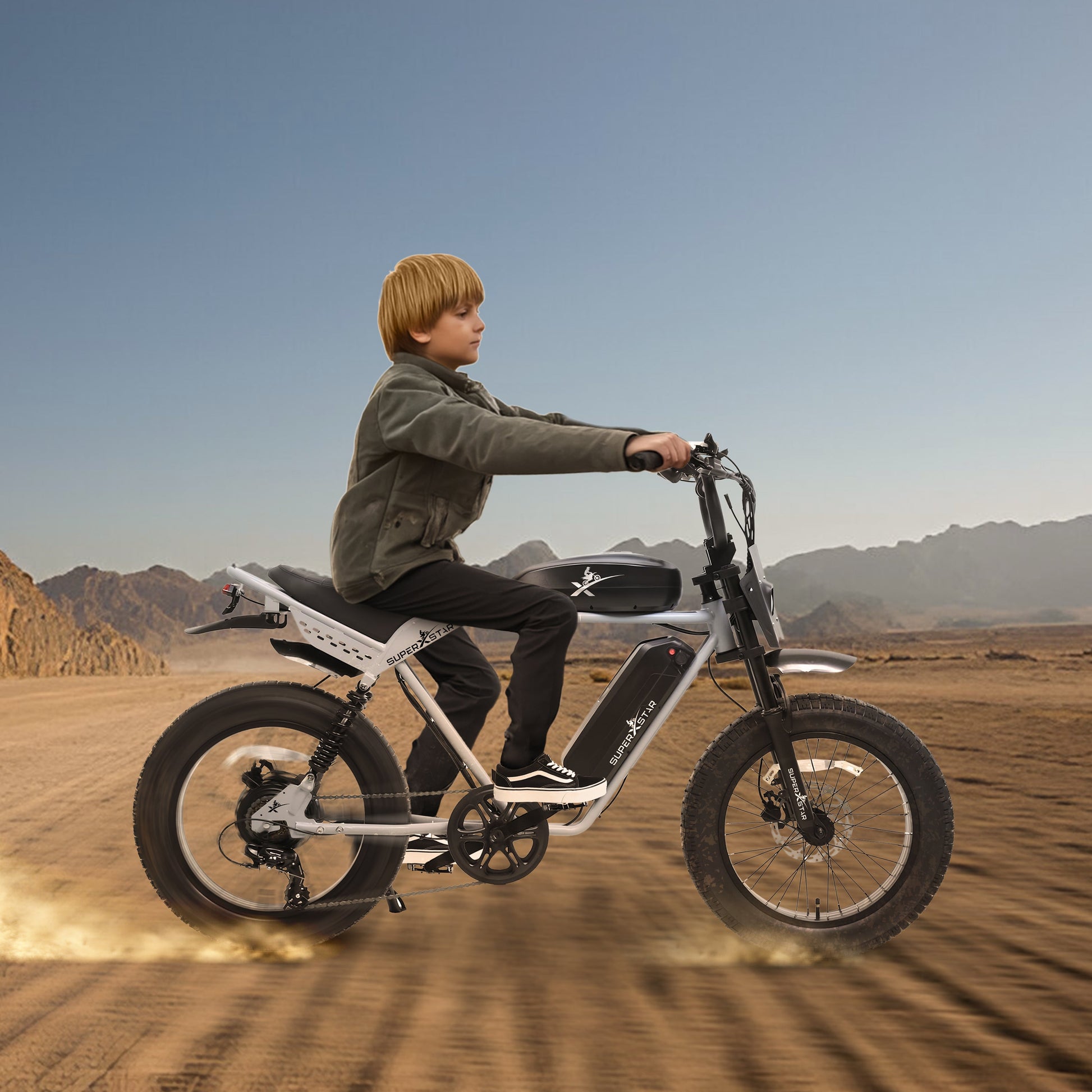 Child riding Super X Star E Times Tour 750W electric bike with dual battery on desert terrain